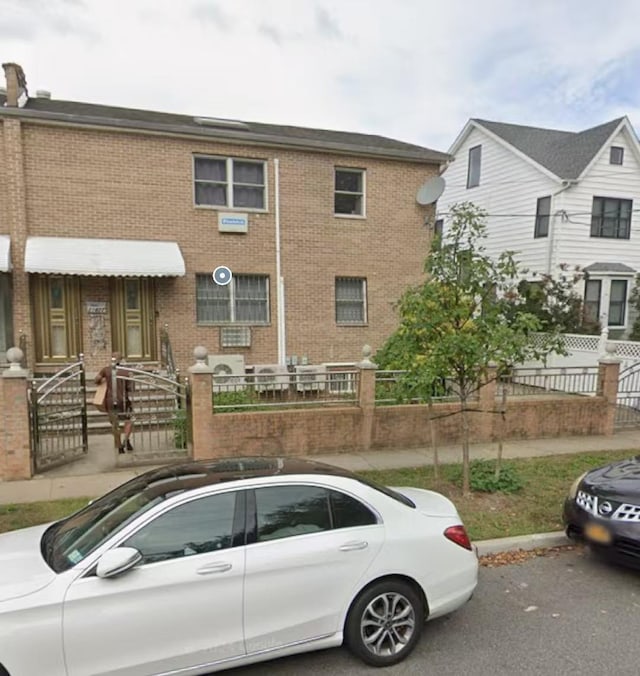 214-27 38th Ave, Bayside, NY 11361 - view of front of property with a fenced front yard and brick siding