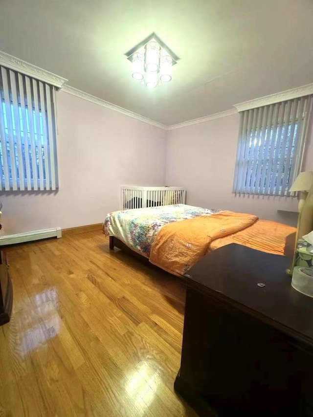 214-27 38th Ave, Bayside, NY 11361 - bedroom with wood finished floors, ornamental molding, baseboards, and baseboard heating