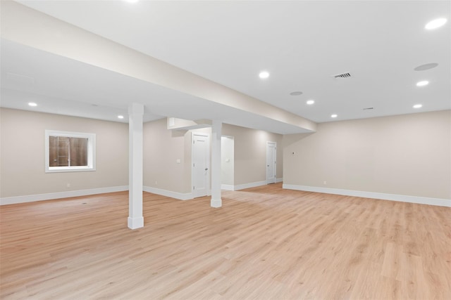 finished basement with light wood finished floors, baseboards, and recessed lighting