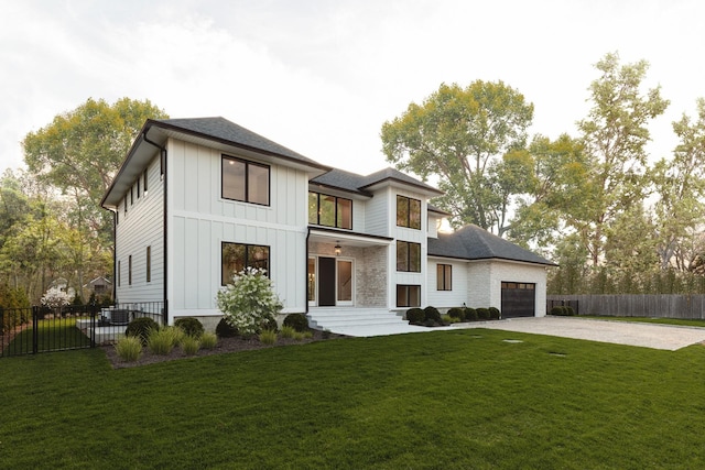 view of front of home with board and batten siding, driveway, a garage, and a shingled roof