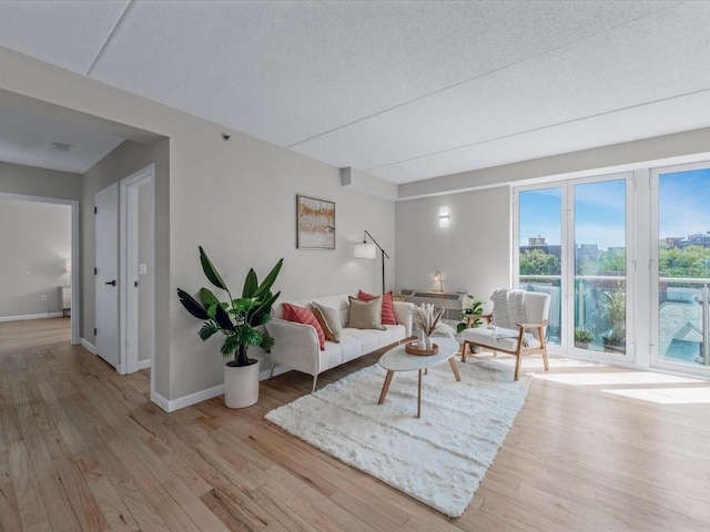 88-20 Parsons Blvd Unit 6D, Jamaica, NY 11432 - living room featuring light wood-type flooring, baseboards, a textured ceiling, and a view of city