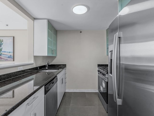 88-20 Parsons Blvd Unit 6D, Jamaica, NY 11432 - kitchen with appliances with stainless steel finishes, a sink, dark stone countertops, glass insert cabinets, and white cabinets