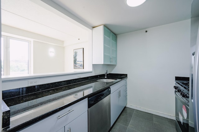 88-20 Parsons Blvd Unit 6D, Jamaica, NY 11432 - kitchen featuring dishwasher, a sink, gas stove, dark stone counters, and glass insert cabinets