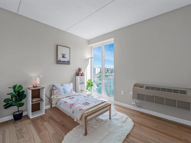 88-20 Parsons Blvd Unit 6D, Jamaica, NY 11432 - bedroom featuring wood finished floors, baseboards, and access to exterior