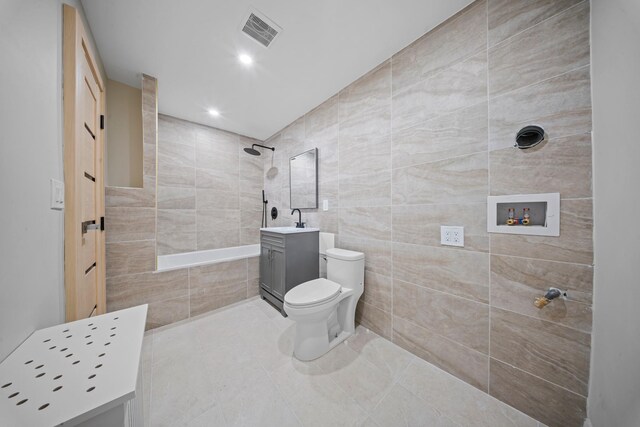 530 Sutter Ave, Brooklyn, NY 11207 - bathroom with tile walls, toilet, tile patterned floors, vanity, and recessed lighting