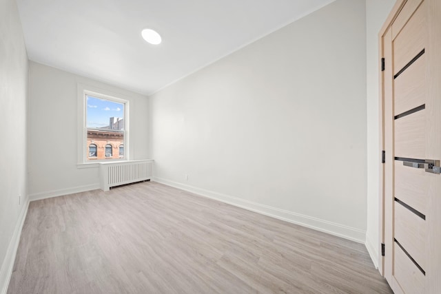 530 Sutter Ave, Brooklyn, NY 11207 - empty room with radiator, light wood-style floors, and baseboards