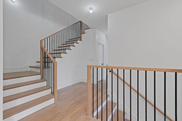staircase with wood finished floors