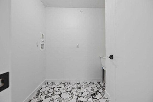 laundry room with washer hookup and baseboards