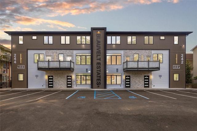 property at dusk with uncovered parking