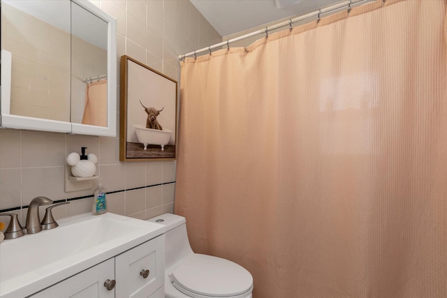 full bath with tile walls, toilet, decorative backsplash, and vanity