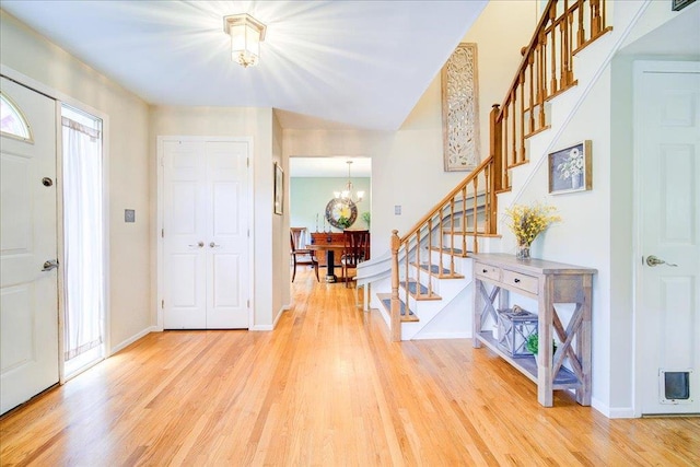 7 Cambridge Cir, Monroe, NY 10950 - foyer featuring stairway, a chandelier, light wood-style flooring, and baseboards
