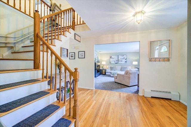 7 Cambridge Cir, Monroe, NY 10950 - stairs with baseboard heating, wood finished floors, and baseboards