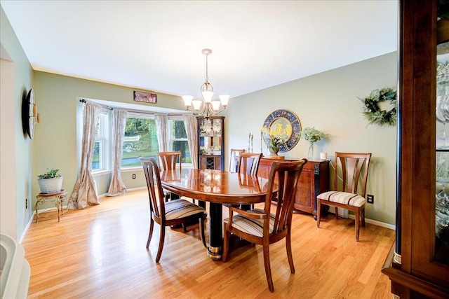7 Cambridge Cir, Monroe, NY 10950 - dining space featuring a chandelier, light wood-style flooring, and baseboards