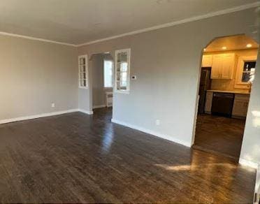 158-38 84th St, Howard Beach, NY 11414 - unfurnished living room featuring arched walkways, dark wood-style flooring, baseboards, and crown molding