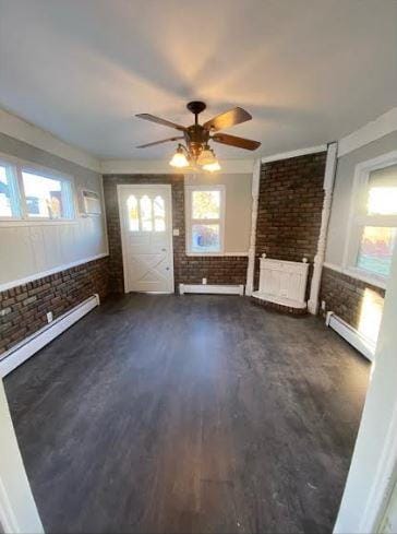 158-38 84th St, Howard Beach, NY 11414 - unfurnished living room with brick wall, baseboard heating, dark wood-style flooring, ceiling fan, and crown molding