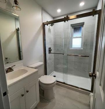158-38 84th St, Howard Beach, NY 11414 - full bathroom featuring a stall shower, toilet, vanity, recessed lighting, and marble finish floors
