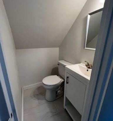 158-38 84th St, Howard Beach, NY 11414 - bathroom featuring lofted ceiling, toilet, and vanity