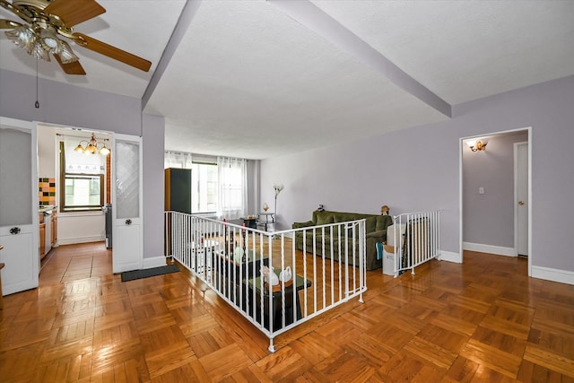 98-51 64th Ave Unit 2C, Rego Park, NY 11374 - hall featuring an upstairs landing, plenty of natural light, baseboards, and a chandelier