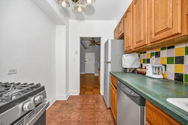 98-51 64th Ave Unit 2C, Rego Park, NY 11374 - kitchen with appliances with stainless steel finishes, dark countertops, a chandelier, and a ceiling fan