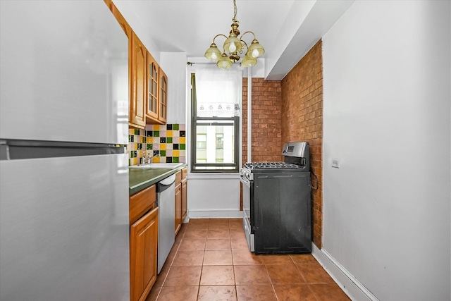 98-51 64th Ave Unit 2C, Rego Park, NY 11374 - kitchen with stainless steel appliances, a chandelier, dark tile patterned flooring, and baseboards