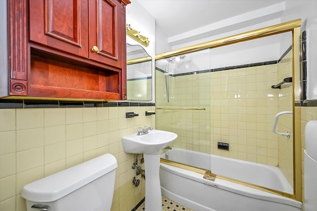 98-51 64th Ave Unit 2C, Rego Park, NY 11374 - bathroom with tile walls, toilet, and combined bath / shower with glass door