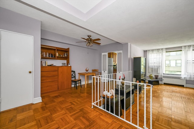 98-51 64th Ave Unit 2C, Rego Park, NY 11374 - hall featuring radiator heating unit, an upstairs landing, and baseboards
