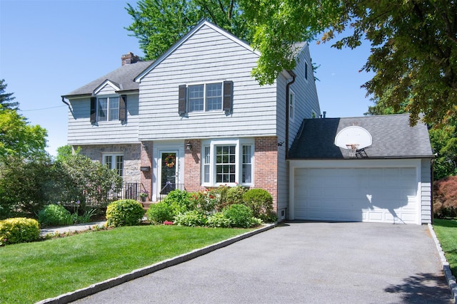 953 Peace St, Pelham, NY 10803 - colonial-style house with asphalt driveway, an attached garage, a front yard, a chimney, and brick siding