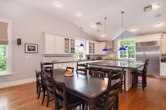 953 Peace St, Pelham, NY 10803 - dining space featuring wood finished floors, vaulted ceiling, and baseboards