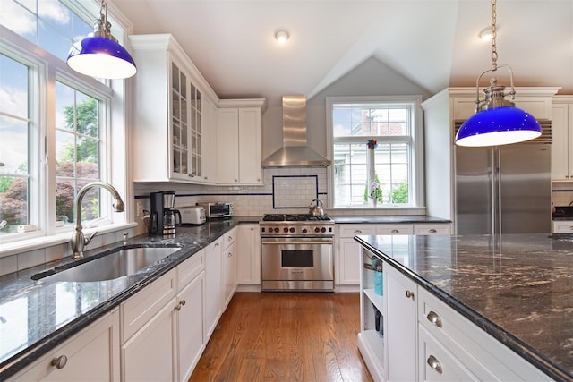 953 Peace St, Pelham, NY 10803 - kitchen with high quality appliances, wall chimney range hood, a sink, healthy amount of natural light, and lofted ceiling