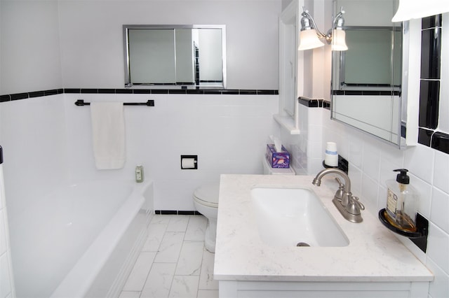 953 Peace St, Pelham, NY 10803 - bathroom with marble look tiles, tile walls, toilet, a tub to relax in, and vanity