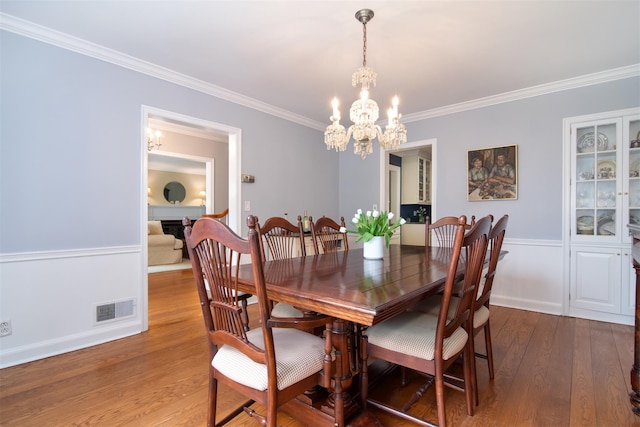 953 Peace St, Pelham, NY 10803 - dining area with a chandelier, crown molding, and wood finished floors
