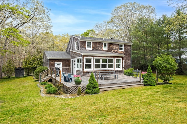 493 Water Mill Towd Rd, Southampton, NY 11968 - back of property with a deck, a lawn, and roof with shingles