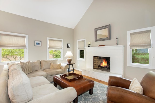 493 Water Mill Towd Rd, Southampton, NY 11968 - living area featuring wood finished floors, high vaulted ceiling, a brick fireplace, and baseboards