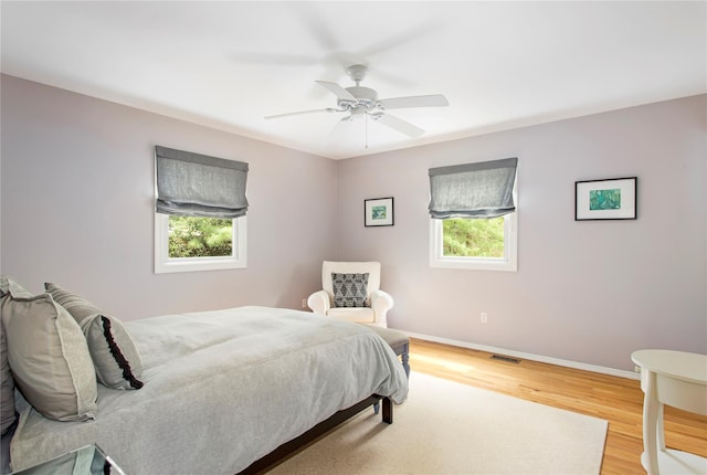 493 Water Mill Towd Rd, Southampton, NY 11968 - bedroom with multiple windows, wood finished floors, baseboards, and a ceiling fan