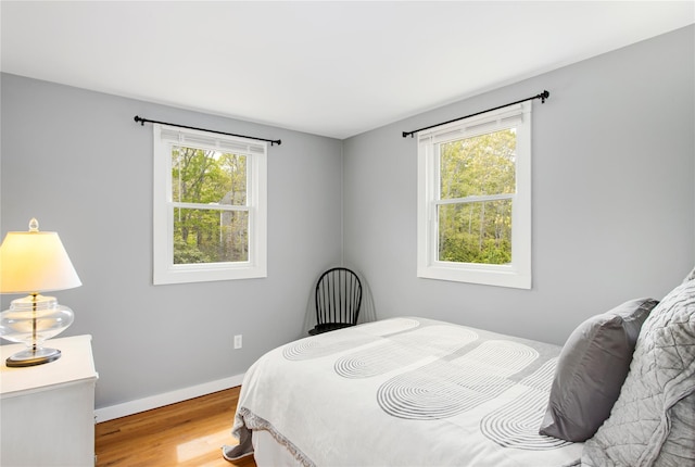 493 Water Mill Towd Rd, Southampton, NY 11968 - bedroom with multiple windows, light wood-type flooring, and baseboards