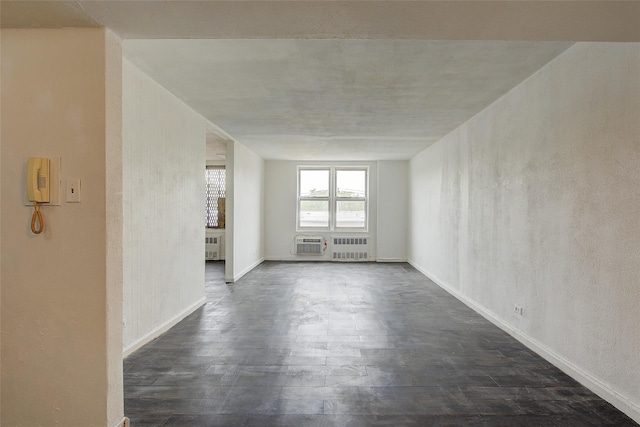 3901 Nostrand Ave Unit 3T, Brooklyn, NY 11235 - unfurnished living room featuring dark wood-type flooring, radiator, baseboards, and a textured wall