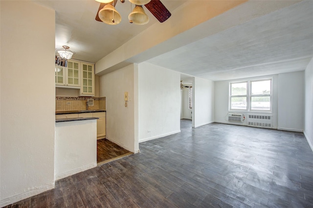 3901 Nostrand Ave Unit 3T, Brooklyn, NY 11235 - unfurnished living room with radiator, an AC wall unit, dark wood-style flooring, ceiling fan, and baseboards