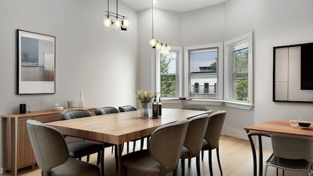 506 E 183rd St, Bronx, NY 10458 - dining room featuring light wood finished floors, baseboards, and a towering ceiling