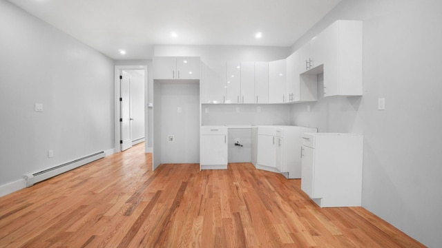 506 E 183rd St, Bronx, NY 10458 - kitchen with baseboard heating, white cabinetry, light wood-style floors, modern cabinets, and recessed lighting