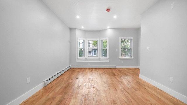 506 E 183rd St, Bronx, NY 10458 - unfurnished room with a baseboard heating unit, light wood finished floors, baseboards, recessed lighting, and a baseboard radiator