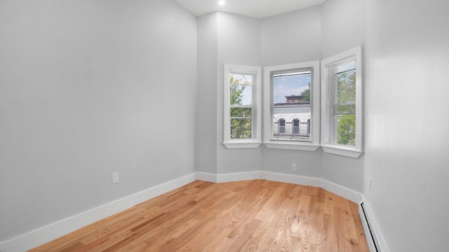 506 E 183rd St, Bronx, NY 10458 - unfurnished room with light wood-type flooring, baseboards, and a baseboard radiator