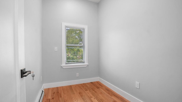 506 E 183rd St, Bronx, NY 10458 - spare room featuring baseboards, light wood finished floors, and a baseboard radiator