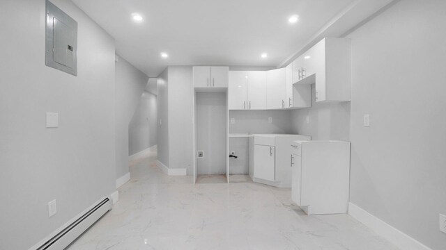 506 E 183rd St, Bronx, NY 10458 - kitchen with baseboard heating, electric panel, recessed lighting, white cabinets, and baseboards