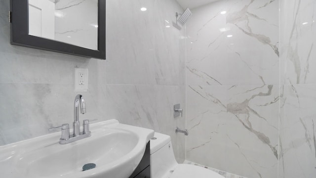 506 E 183rd St, Bronx, NY 10458 - bathroom with a shower, tile walls, vanity, and toilet