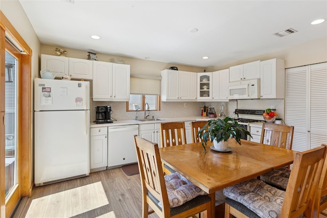 dining area featuring light wood-style floors and recessed lighting