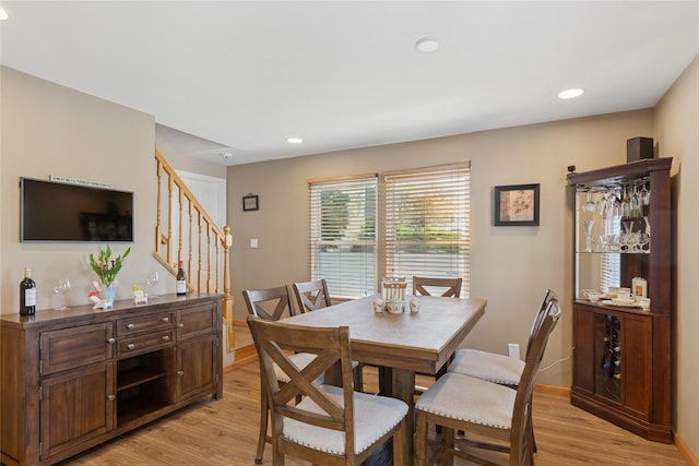 dining area featuring stairway, light wood-style flooring, and recessed lighting