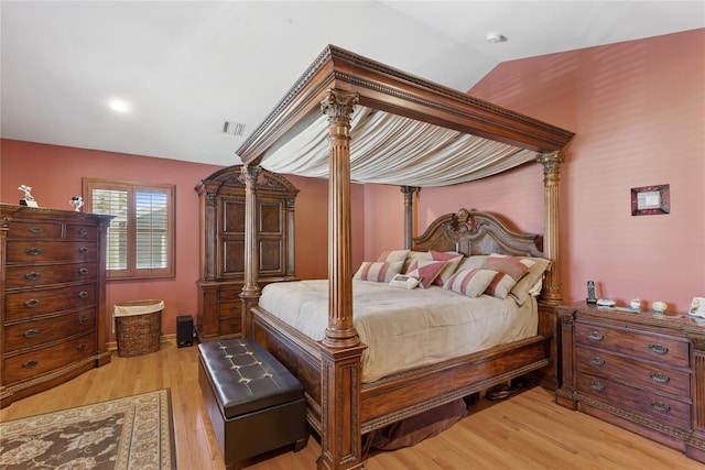 bedroom featuring vaulted ceiling and light wood-style flooring