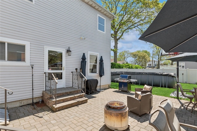 view of patio / terrace featuring an outdoor fire pit, fence, and grilling area