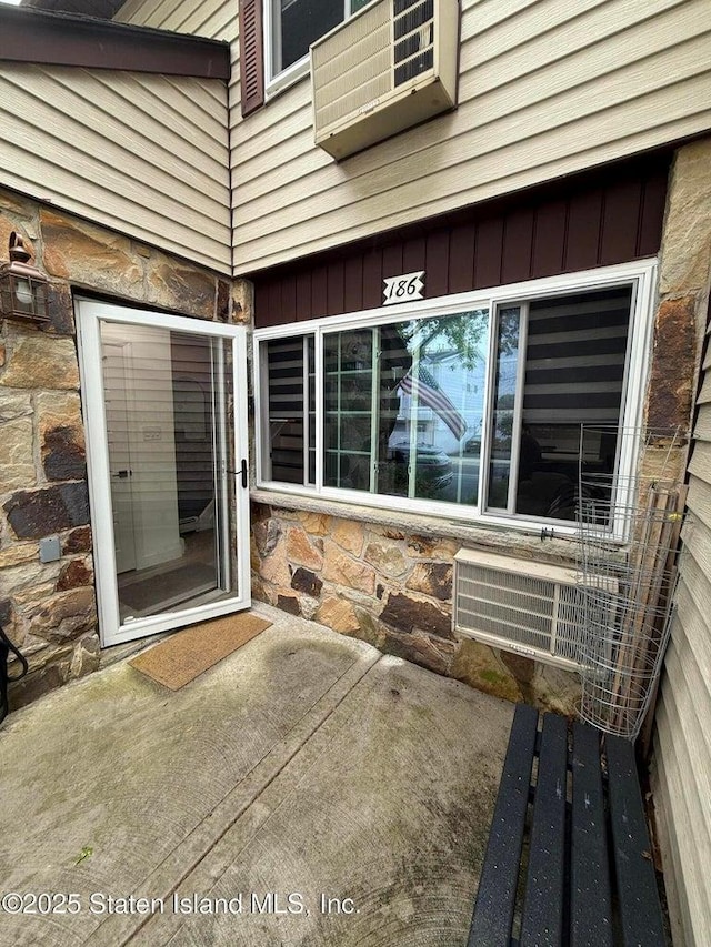 view of exterior entry featuring stone siding