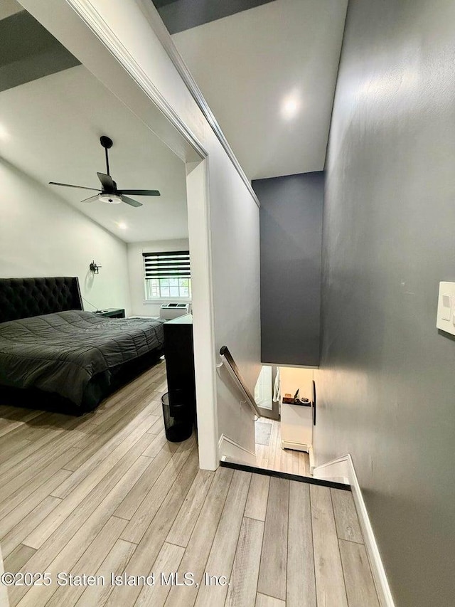 bedroom featuring wood finished floors, ceiling fan, and baseboards